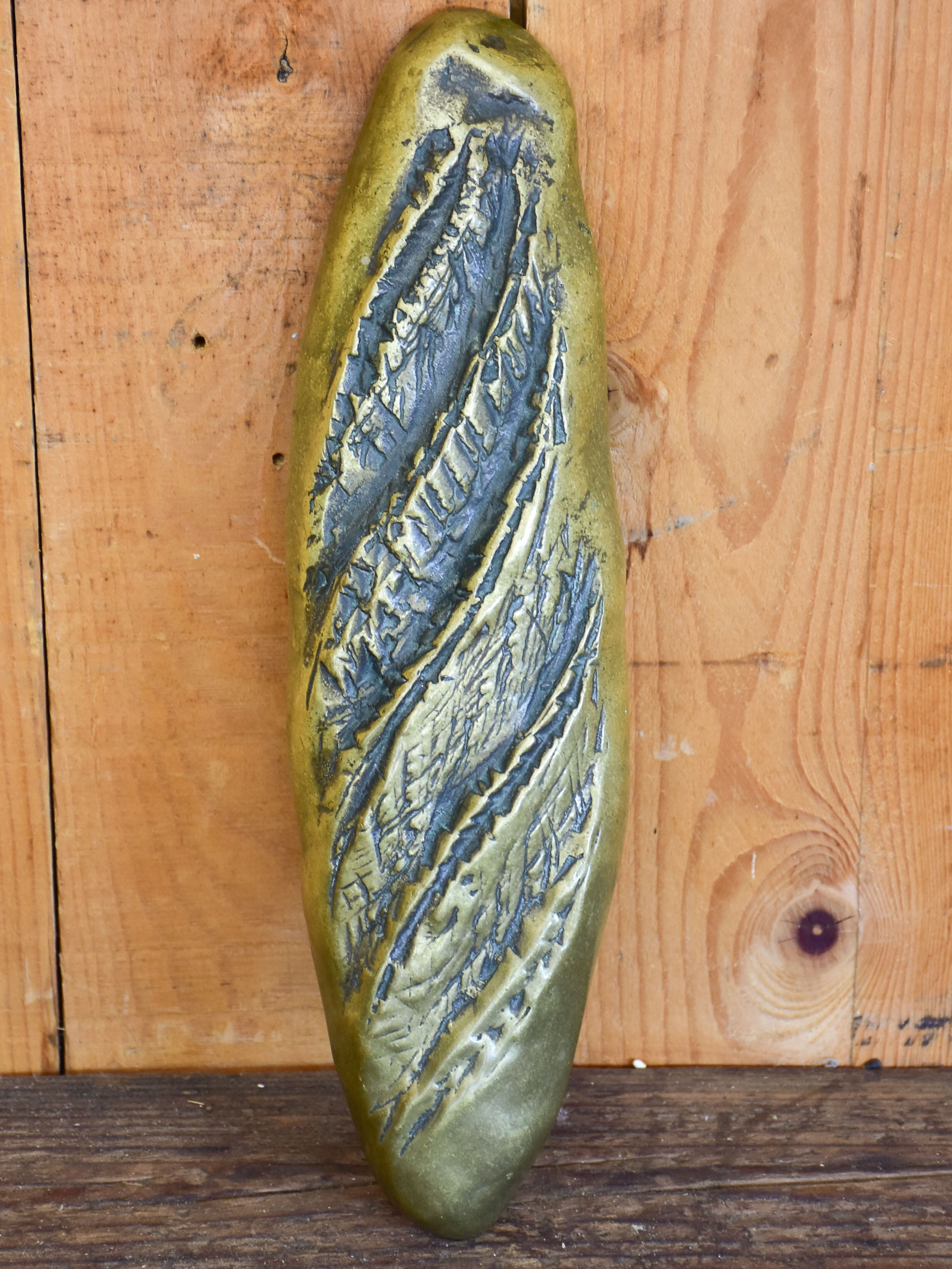 Vintage door handle from a boulangerie in the shape of a baguette