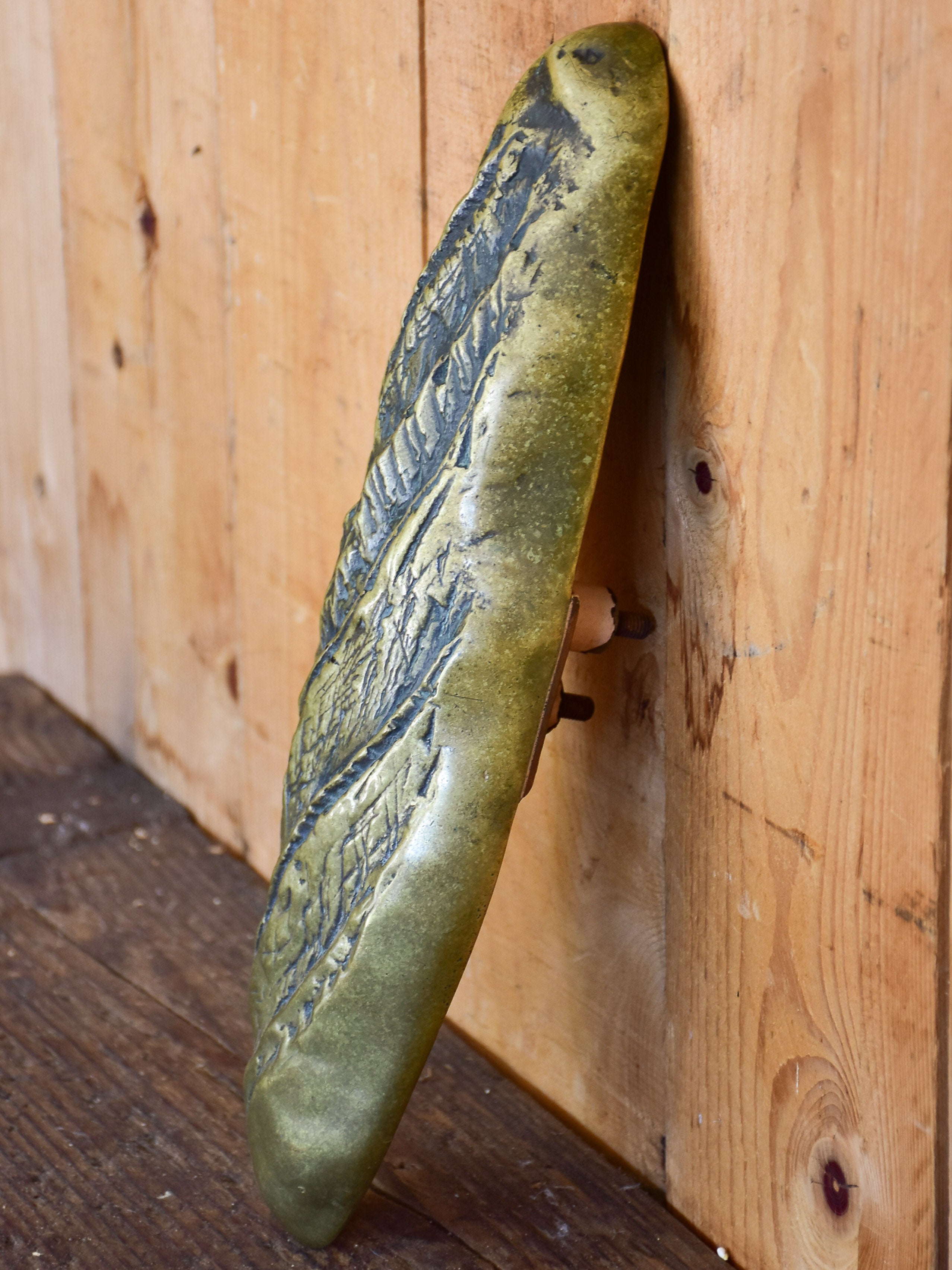 Vintage door handle from a boulangerie in the shape of a baguette