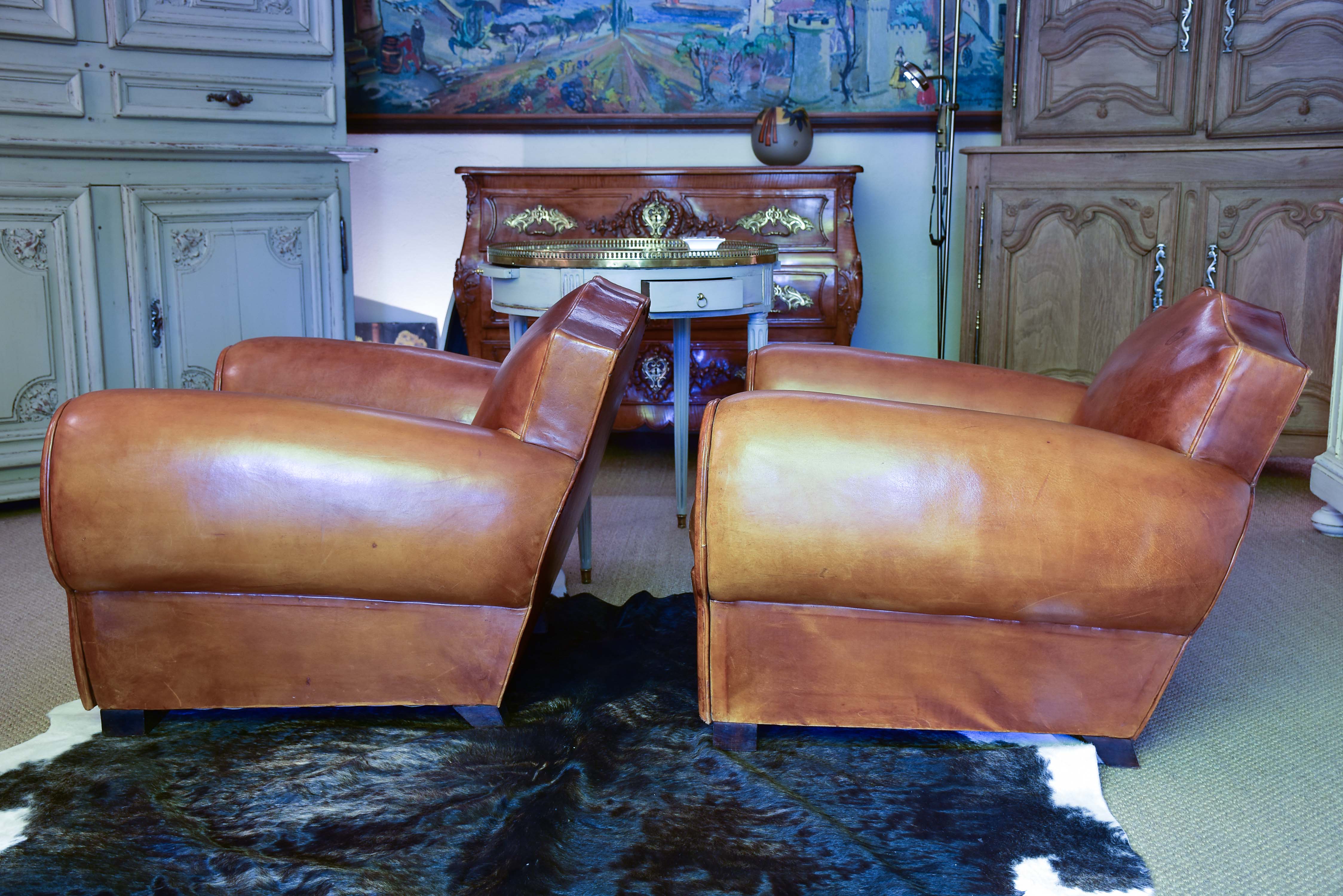 Pair of 1950's moustache back leather club chairs