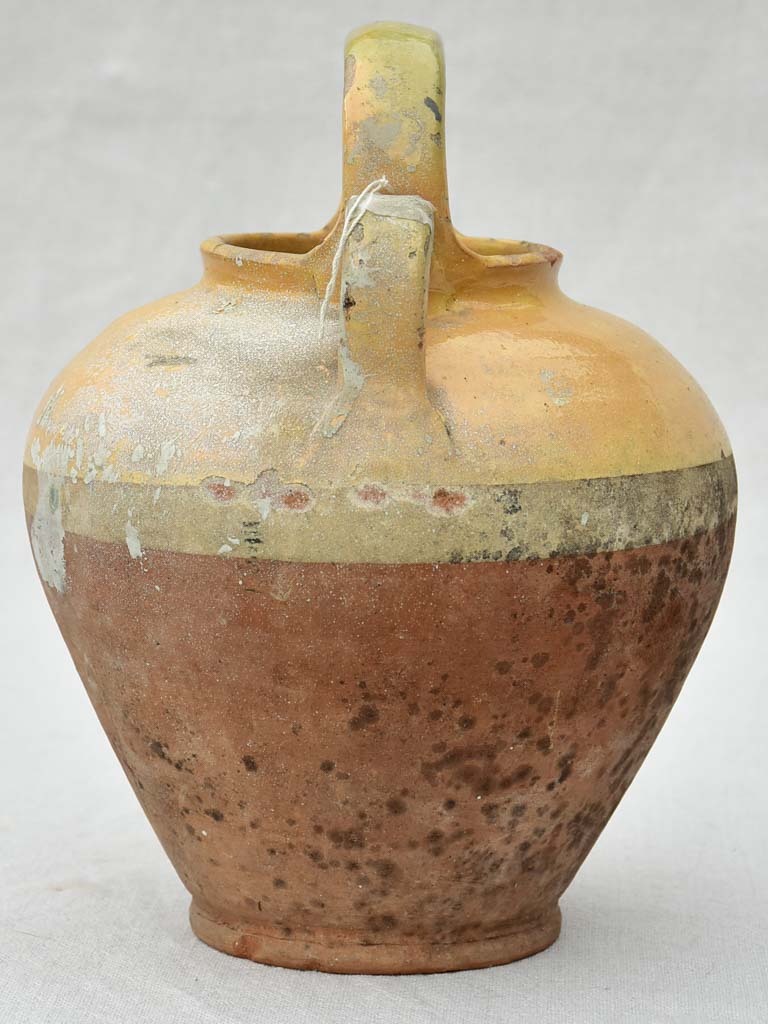 Small antique French water pitcher with yellow glaze 11"