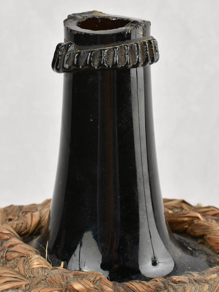 Small demijohn bottle in woven straw basket 12¼"
