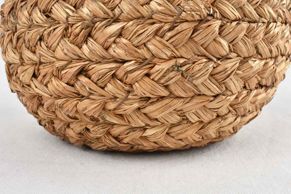 Small demijohn bottle in woven straw basket 12¼"