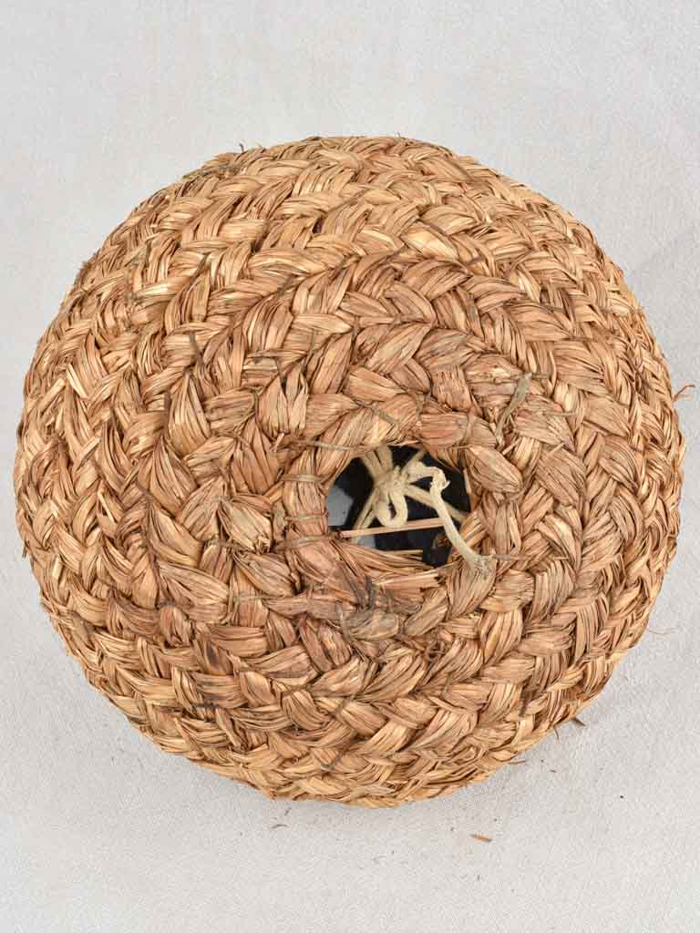 Small demijohn bottle in woven straw basket 12¼"