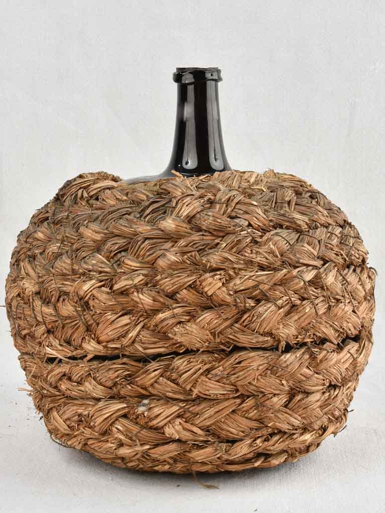 Medium demijohn bottle in woven straw basket 12½"