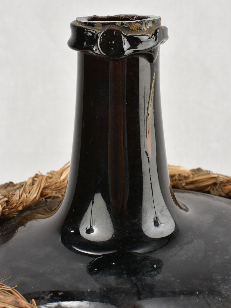 Medium demijohn bottle in woven straw basket 12½"