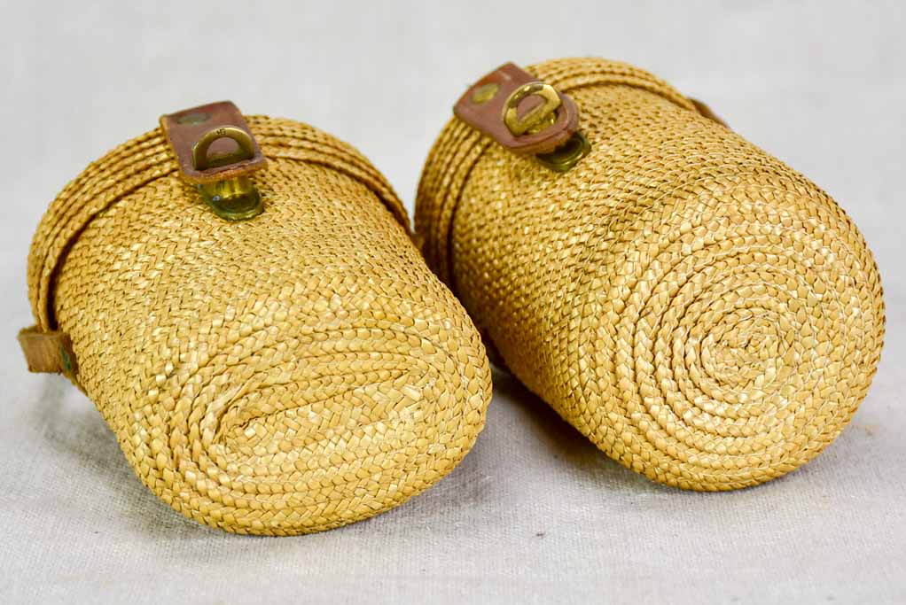 Two mid century French 'verre de cure' glasses in baskets