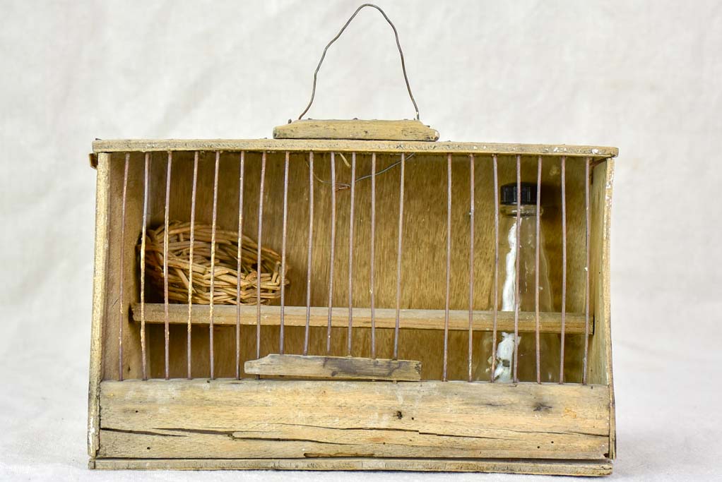 Small 1920's birdcage with nest and water