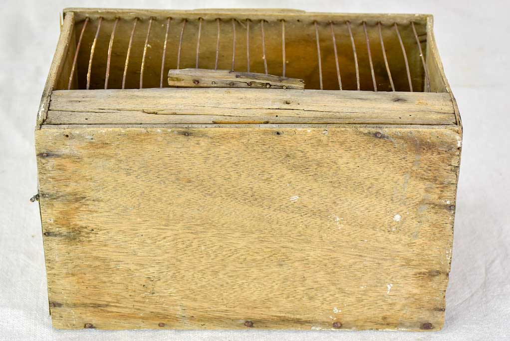 Small 1920's birdcage with nest and water