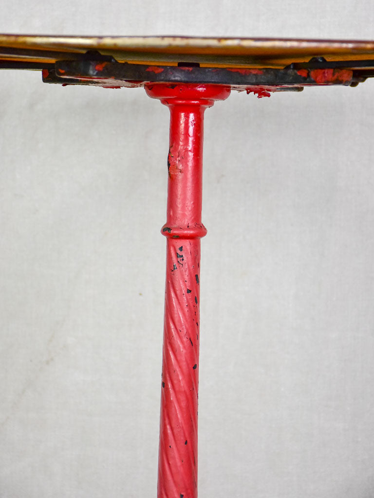 Late nineteenth century French bistro table with red cast iron base