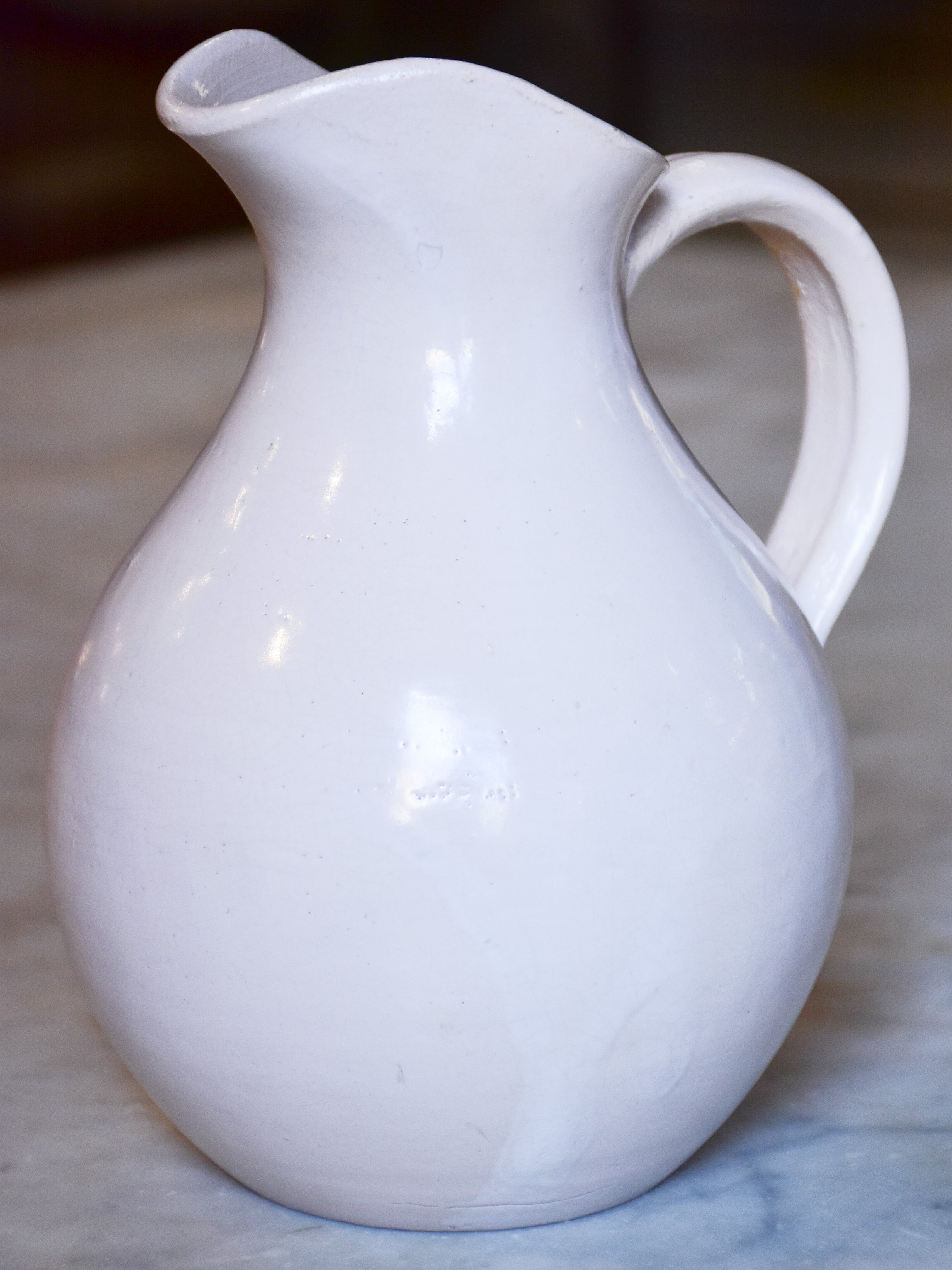 Antique French terracotta pitcher with white glaze