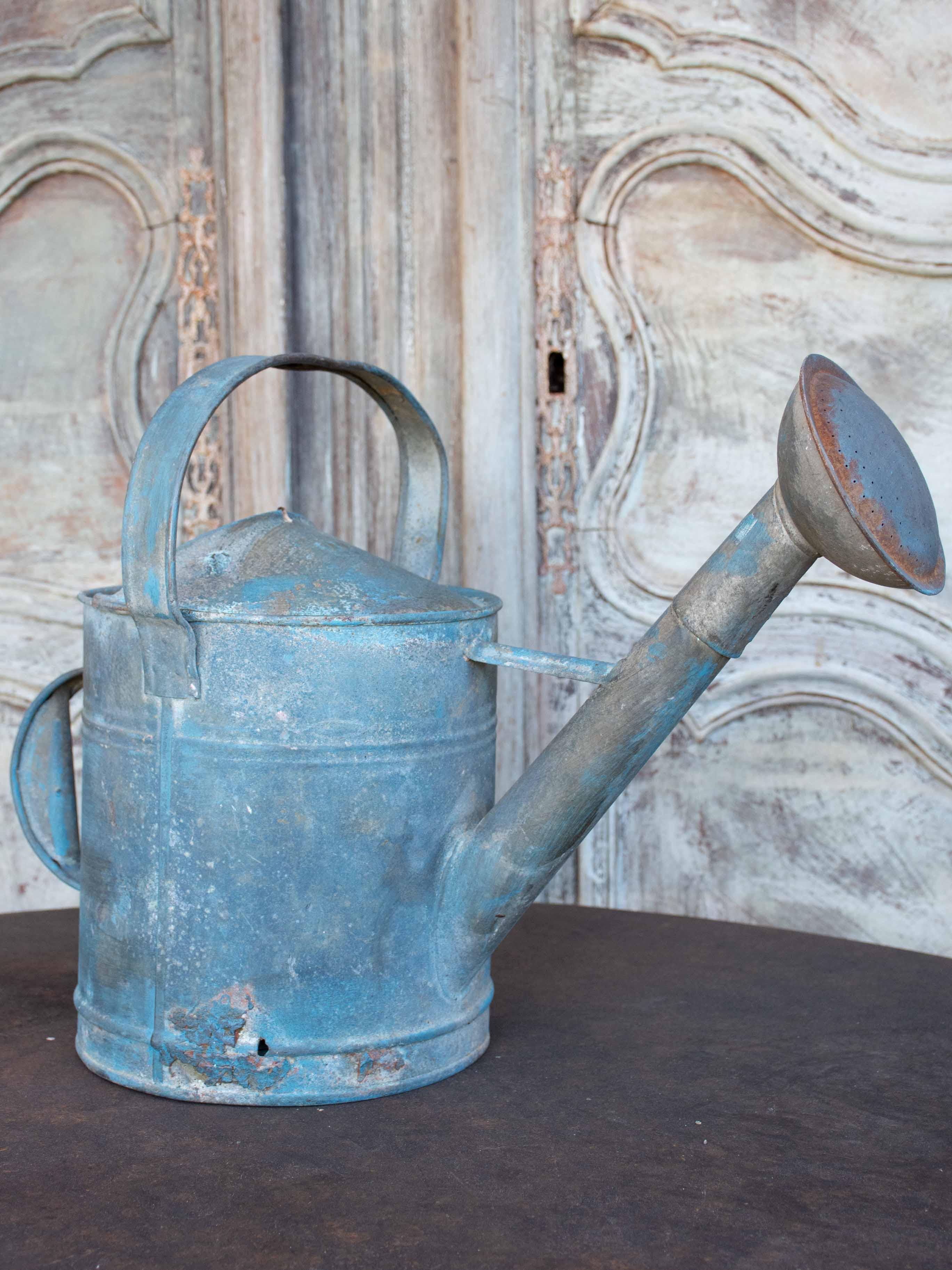 Antique French watering can with blue patina