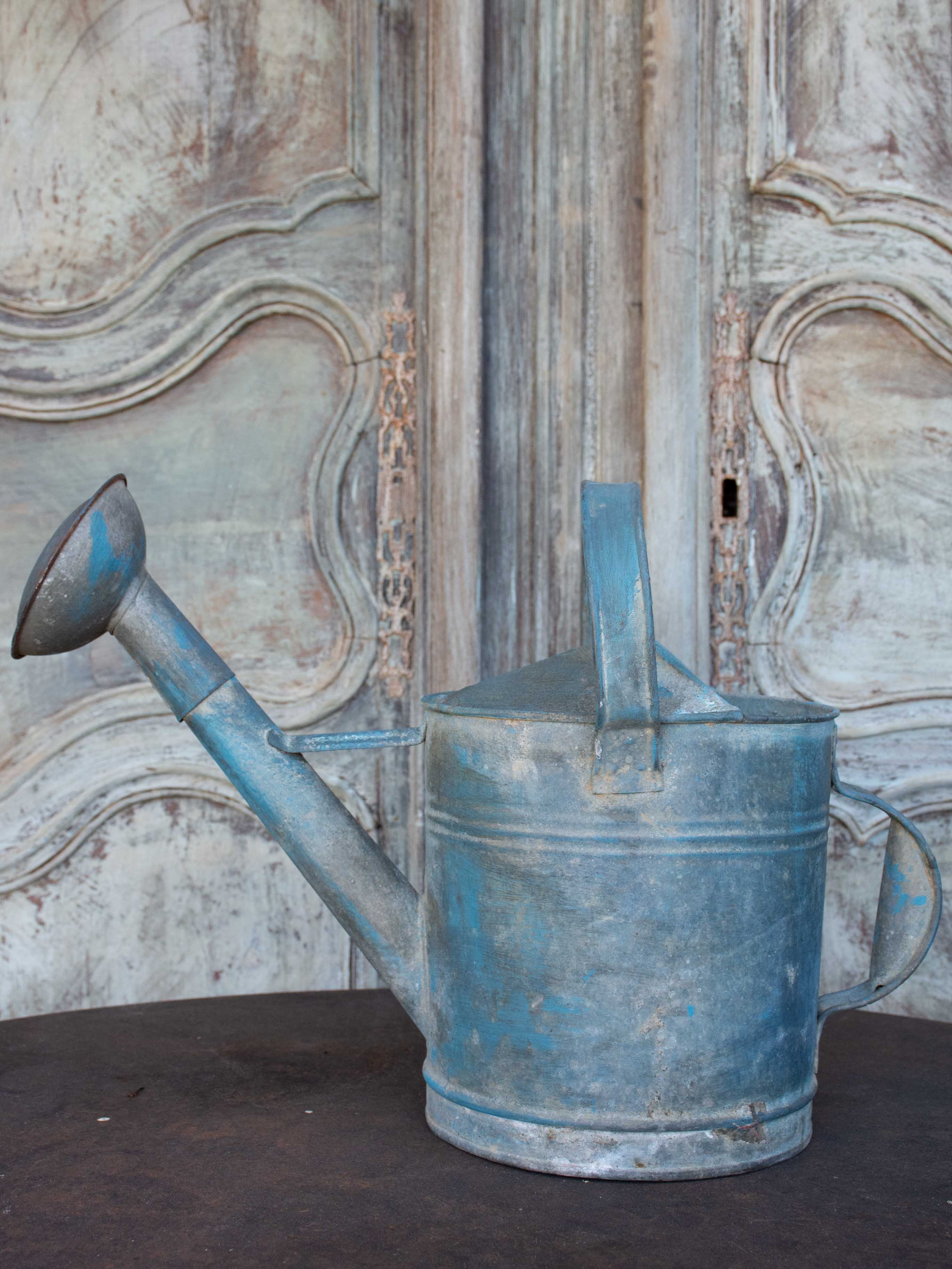 Antique French watering can with blue patina