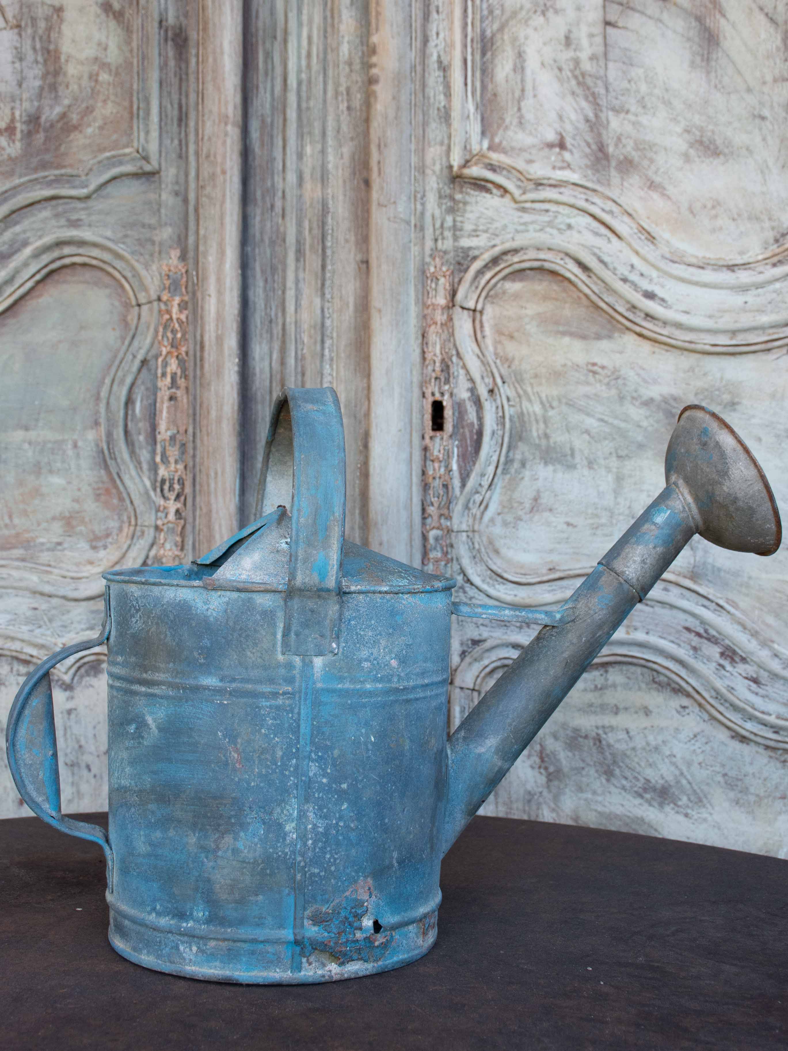 Antique French watering can with blue patina