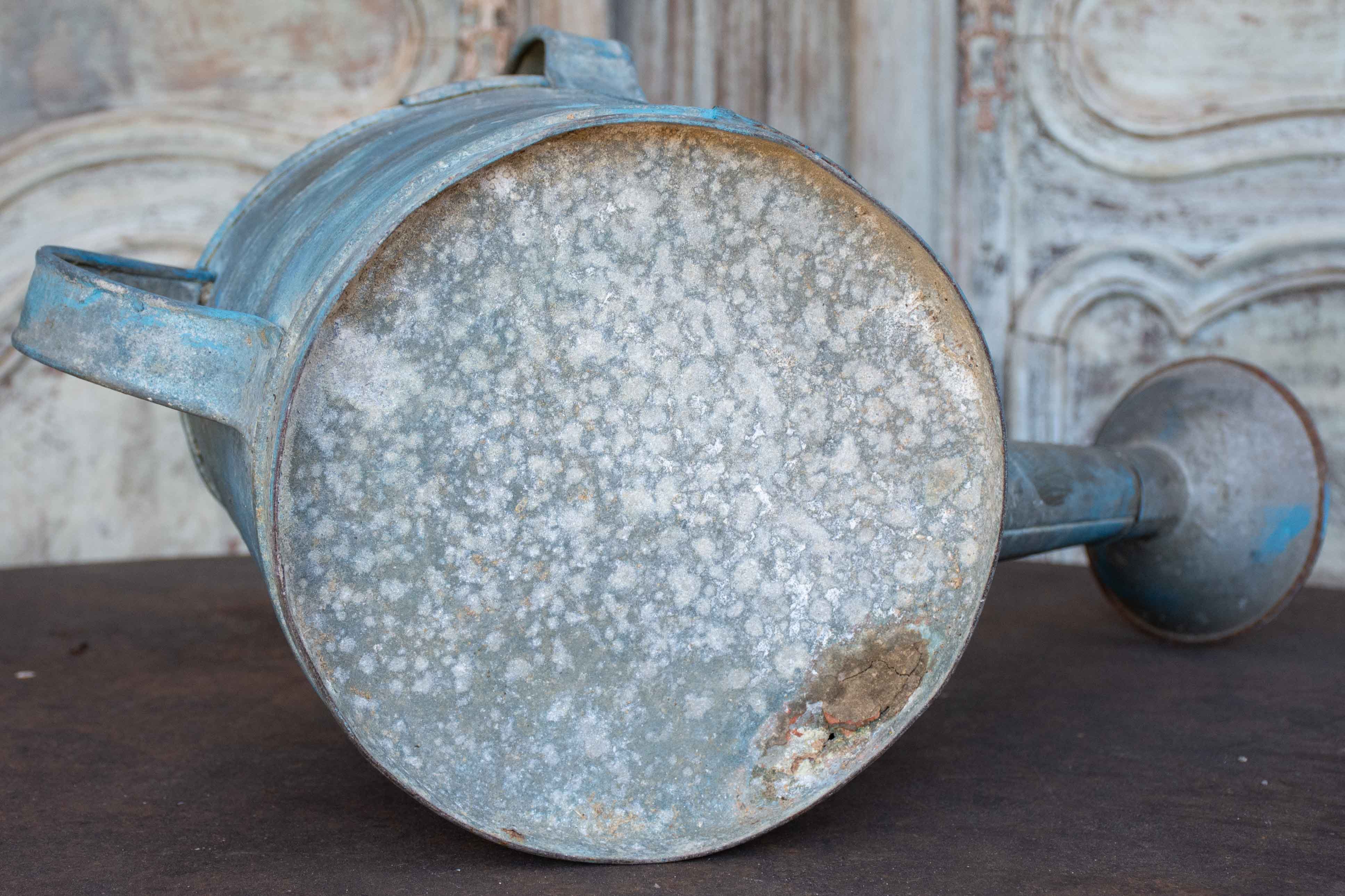 Antique French watering can with blue patina