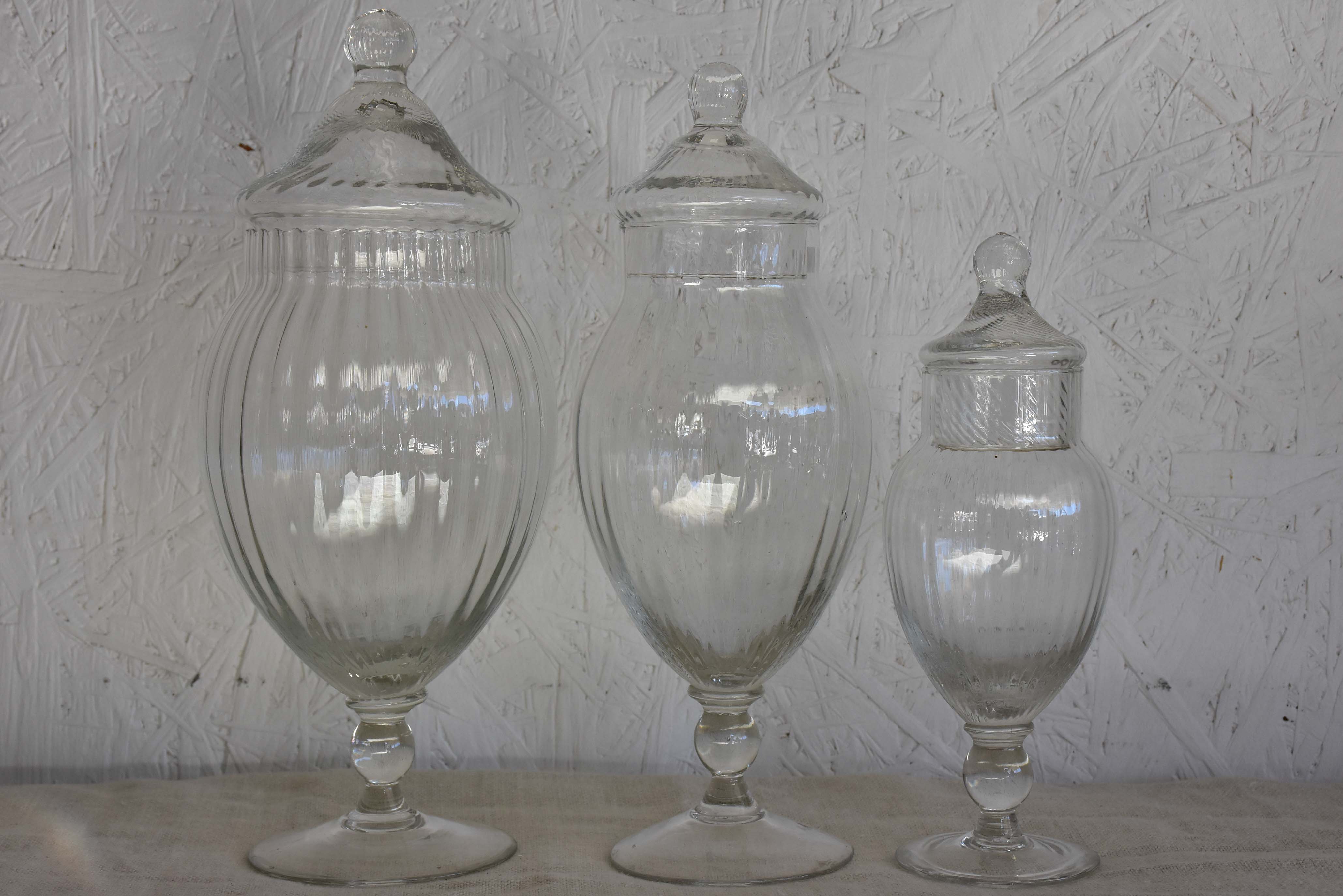 Three vintage French glass vanity jars with lids