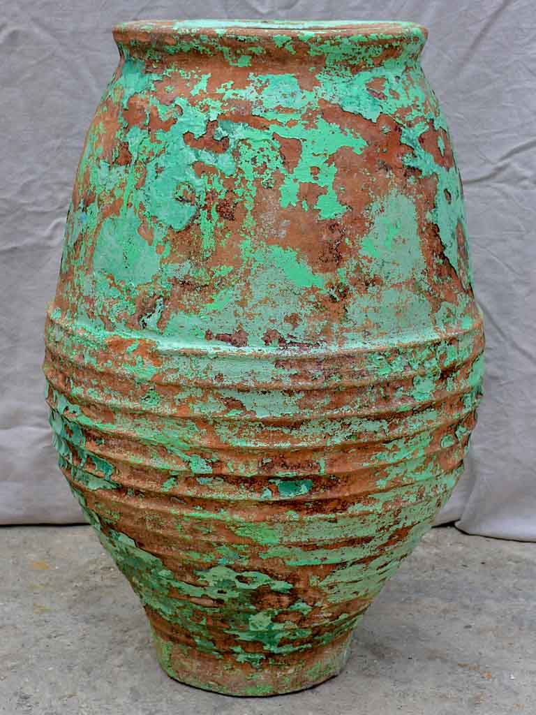 Very large antique Spanish olive oil jar with green patina