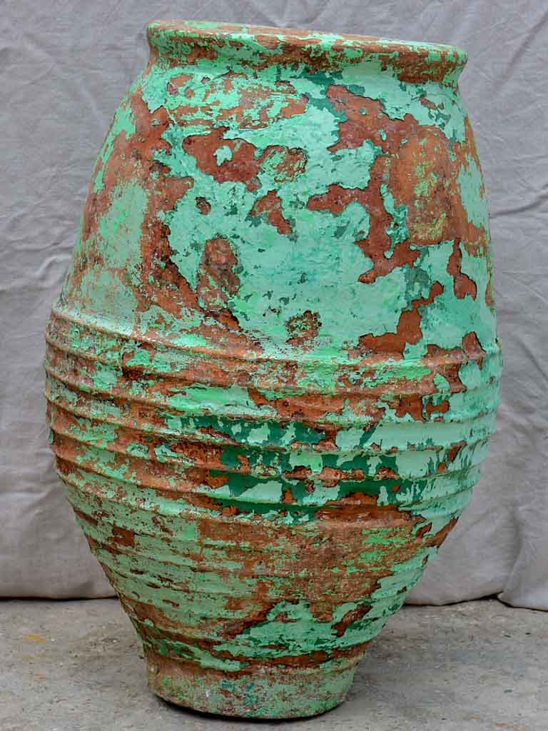 Very large antique Spanish olive oil jar with green patina