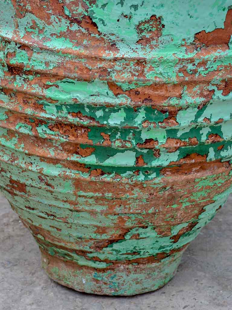 Very large antique Spanish olive oil jar with green patina