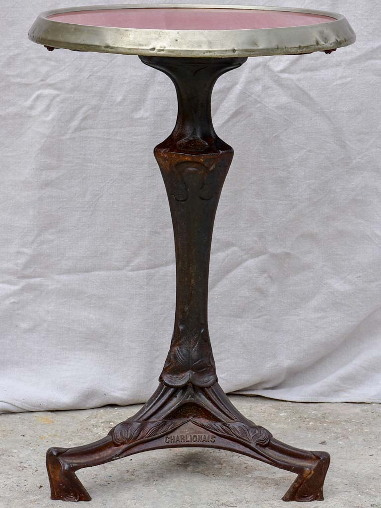 Art Nouveau cast iron bistro table with red glass table top