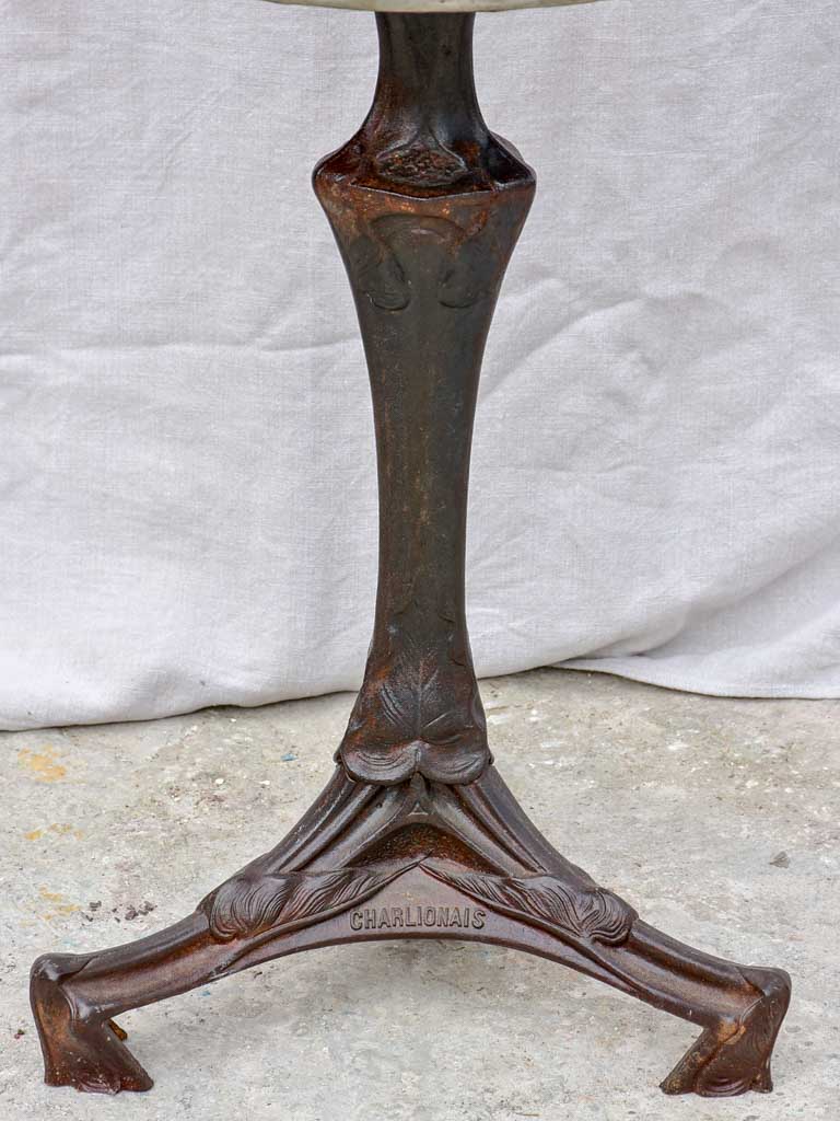 Art Nouveau cast iron bistro table with red glass table top
