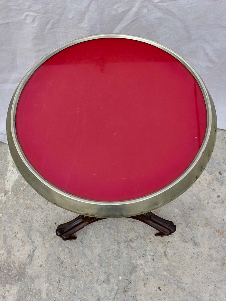 Art Nouveau cast iron bistro table with red glass table top