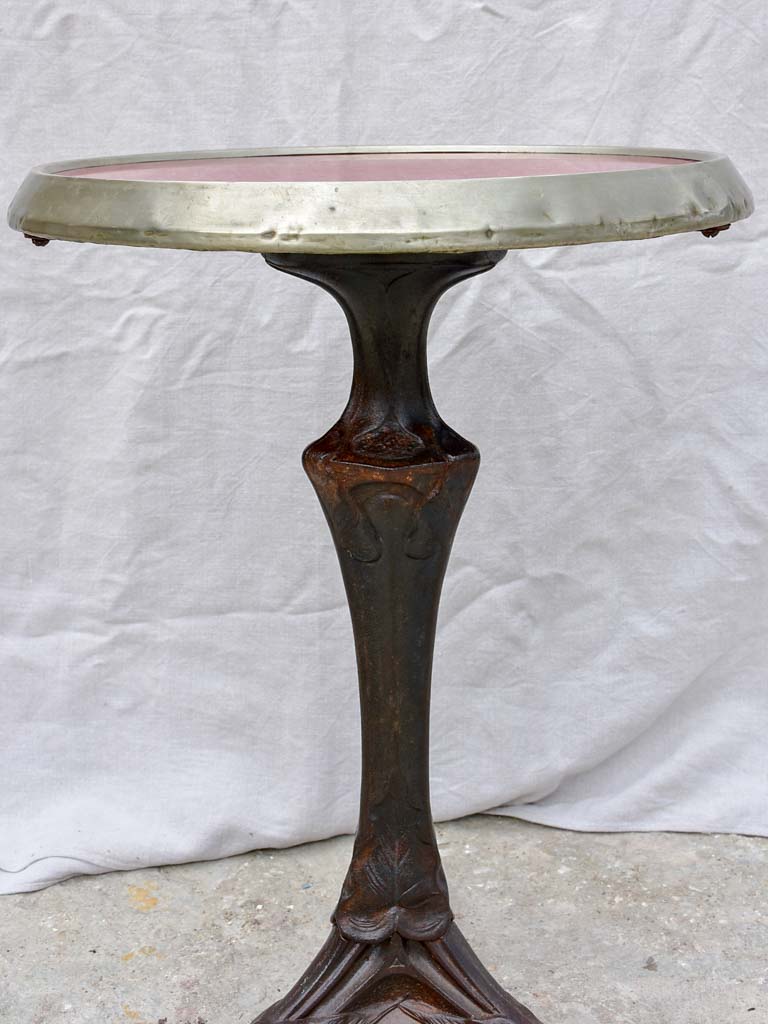Art Nouveau cast iron bistro table with red glass table top