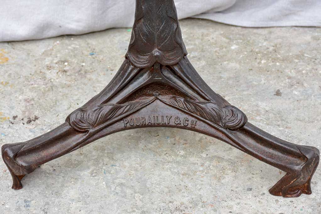 Art Nouveau cast iron bistro table with red glass table top