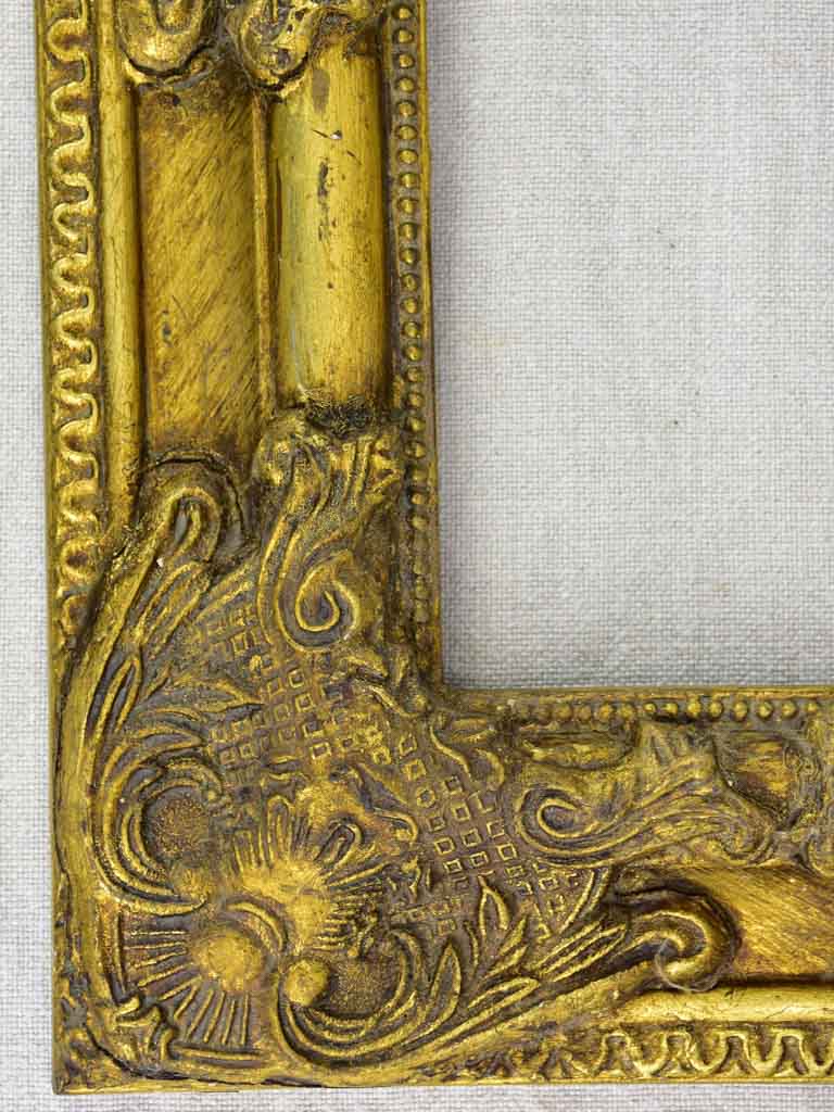 Timber and stucco frame with gold patina