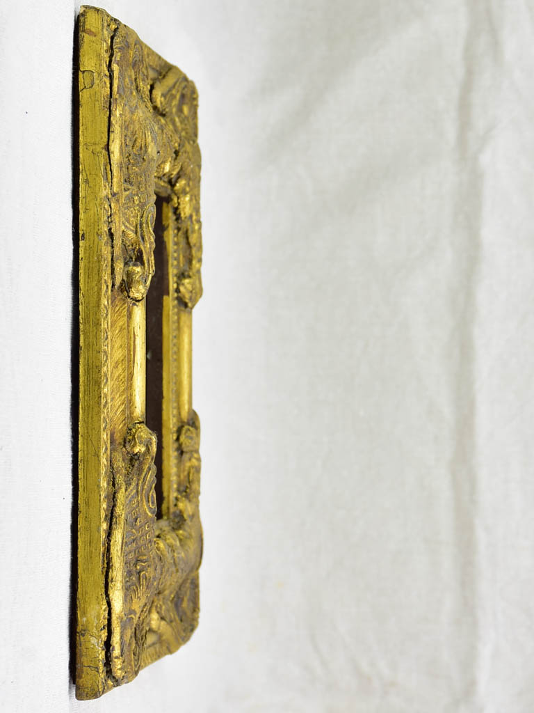 Timber and stucco frame with gold patina