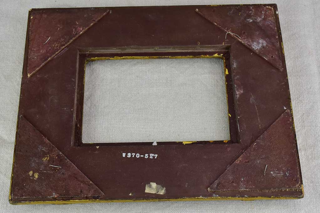 Timber and stucco frame with gold patina