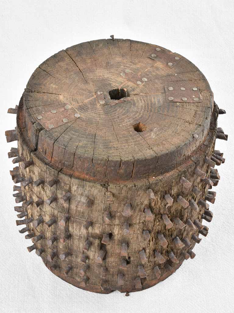 Antique salvaged wooden wheel with metal spikes 9"