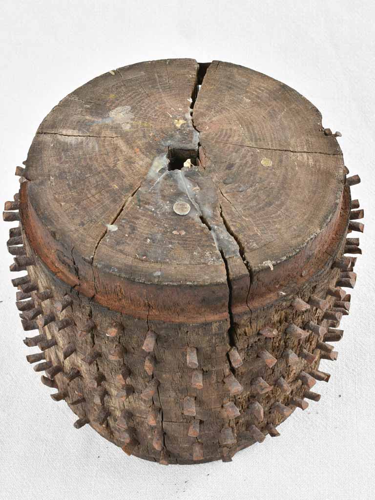 Antique salvaged wooden wheel with metal spikes 9"