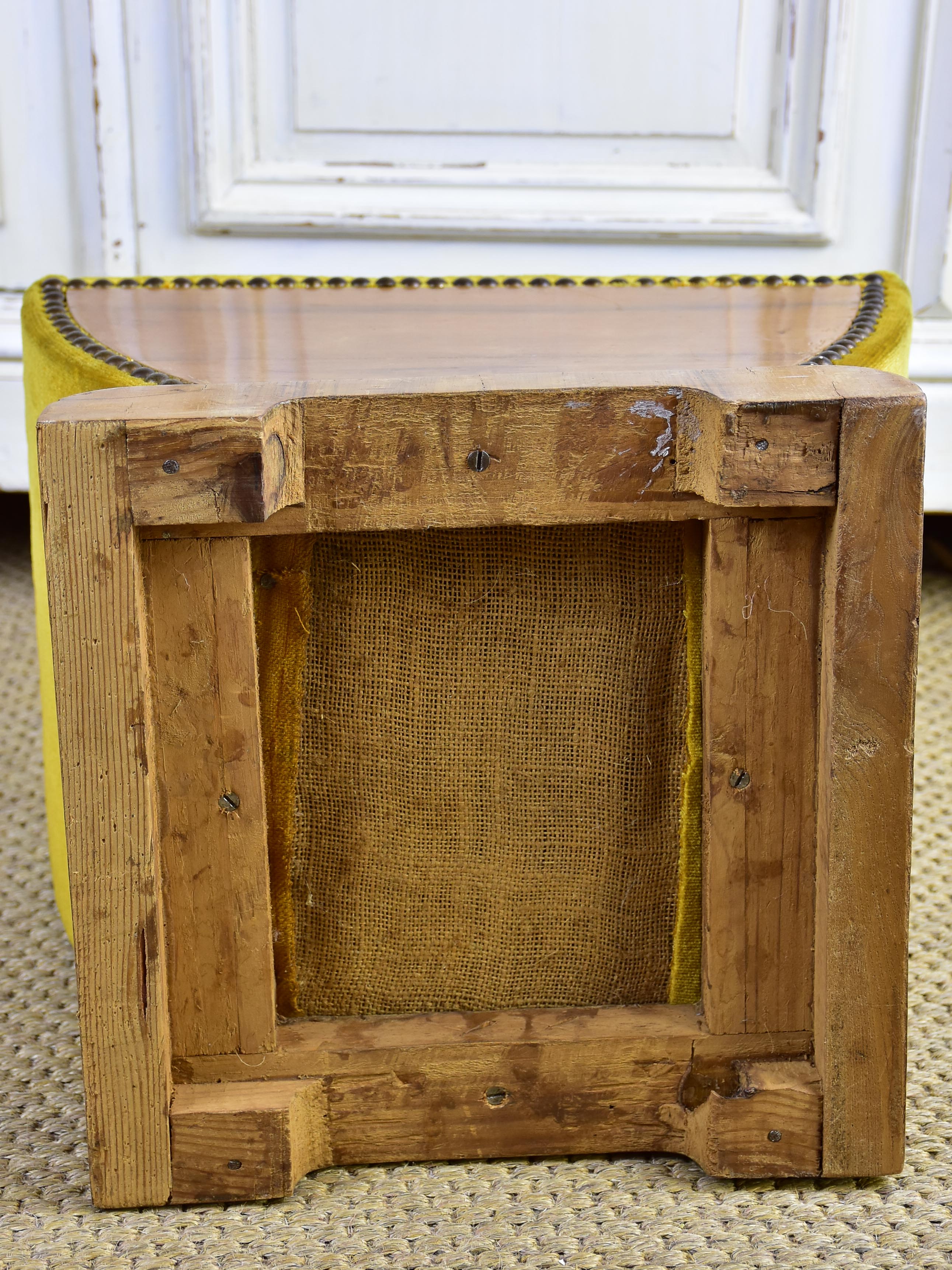 Antique footrest with mustard velvet upholstery