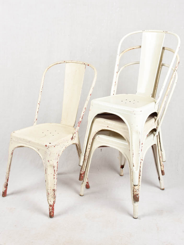 Four 1950s Tolix chairs w/ beige paint finish
