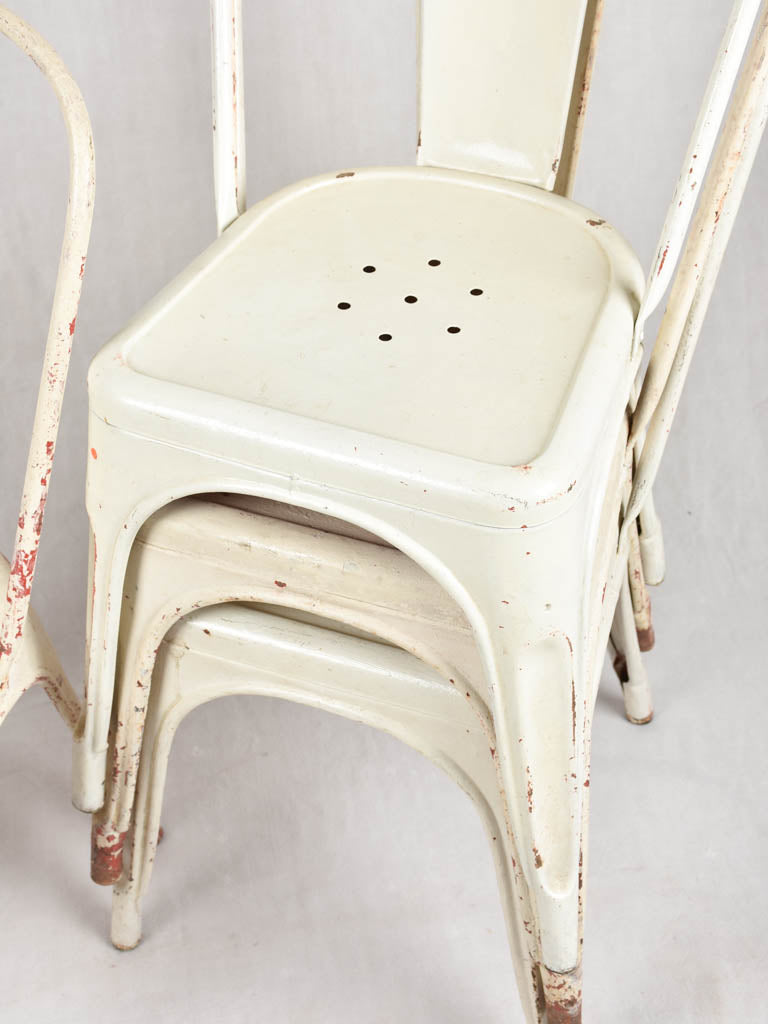 Four 1950s Tolix chairs w/ beige paint finish