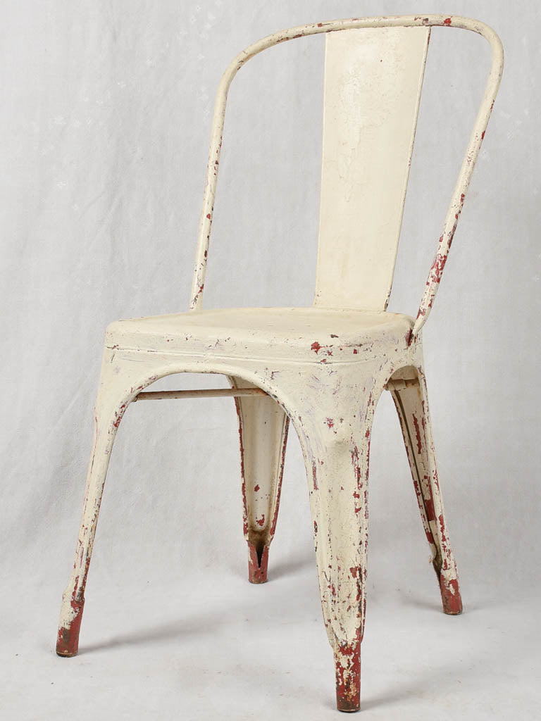 Four 1950s Tolix chairs w/ beige paint finish