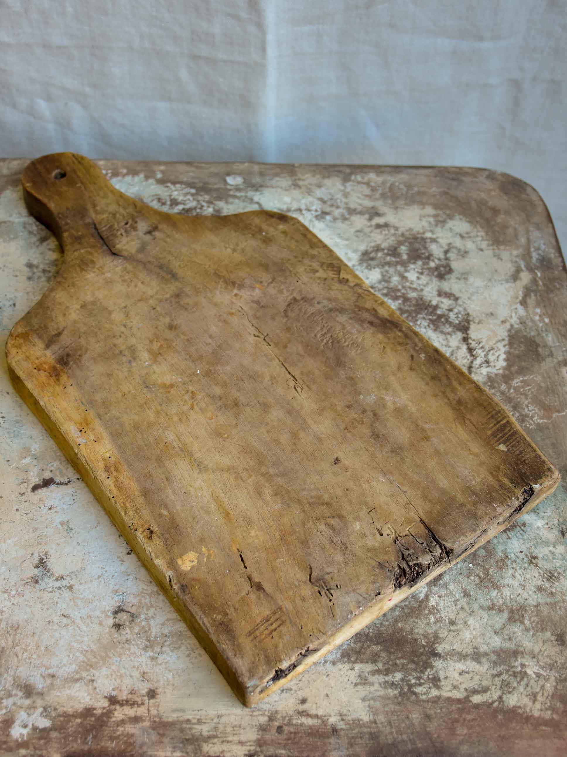 Large antique French cutting board with curved shoulders