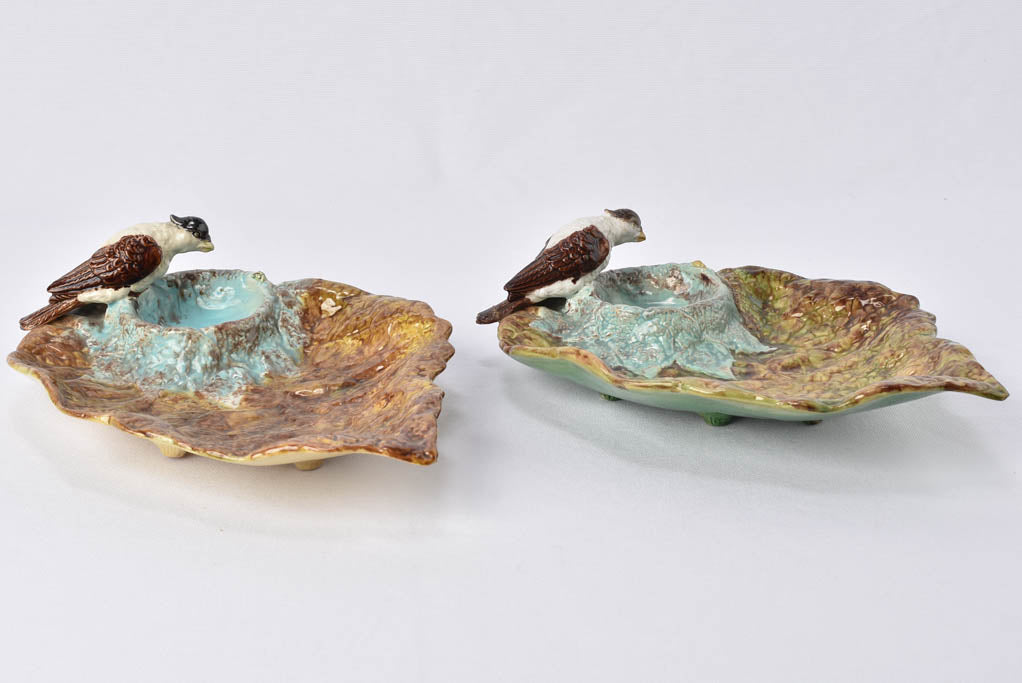Aged majolica plates with bird detail