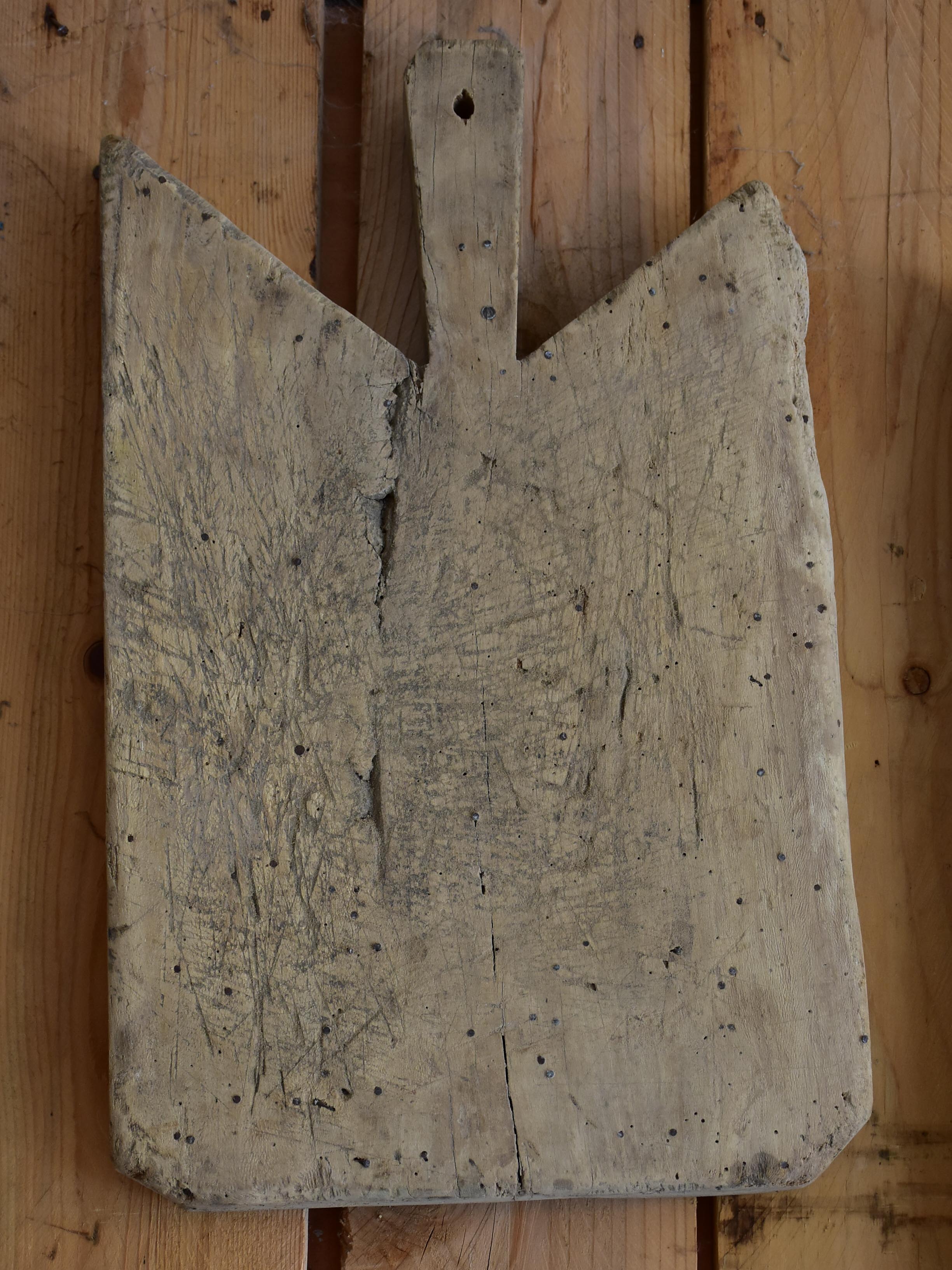 Antique French cutting board with repairs and angled corners