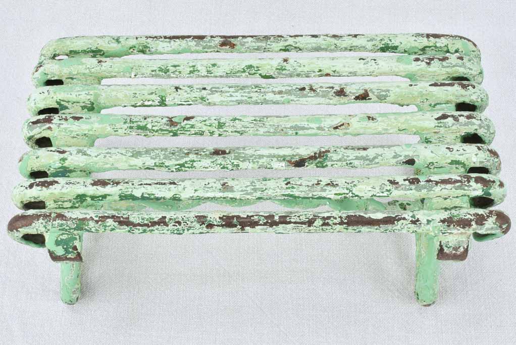 Antique garden footrest with green patina
