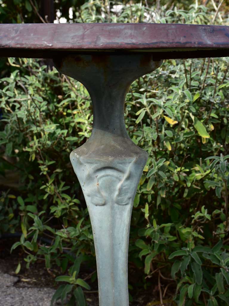 Art Nouveau cast iron bistro table with beige glass table top