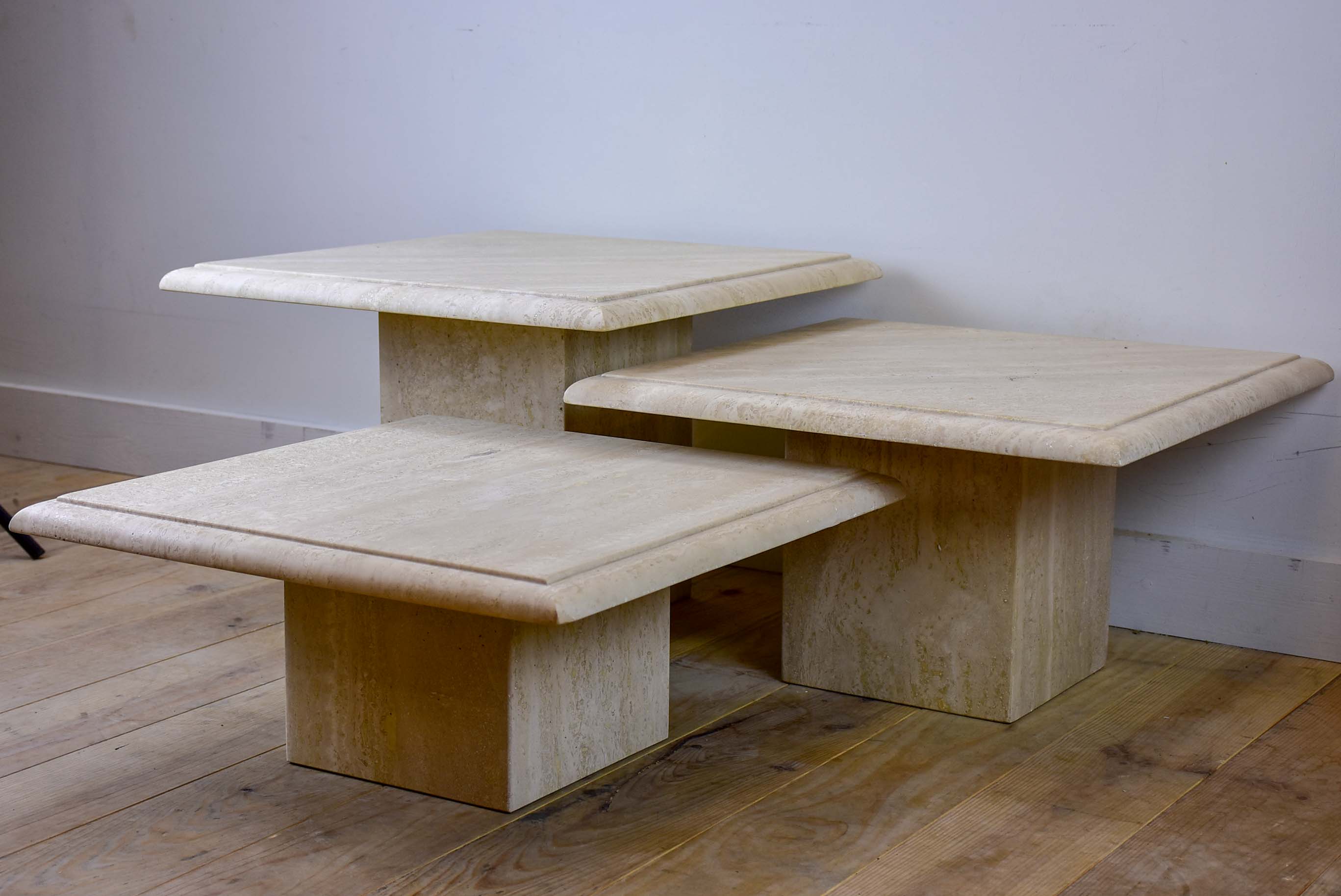 Three vintage travertine nesting side tables