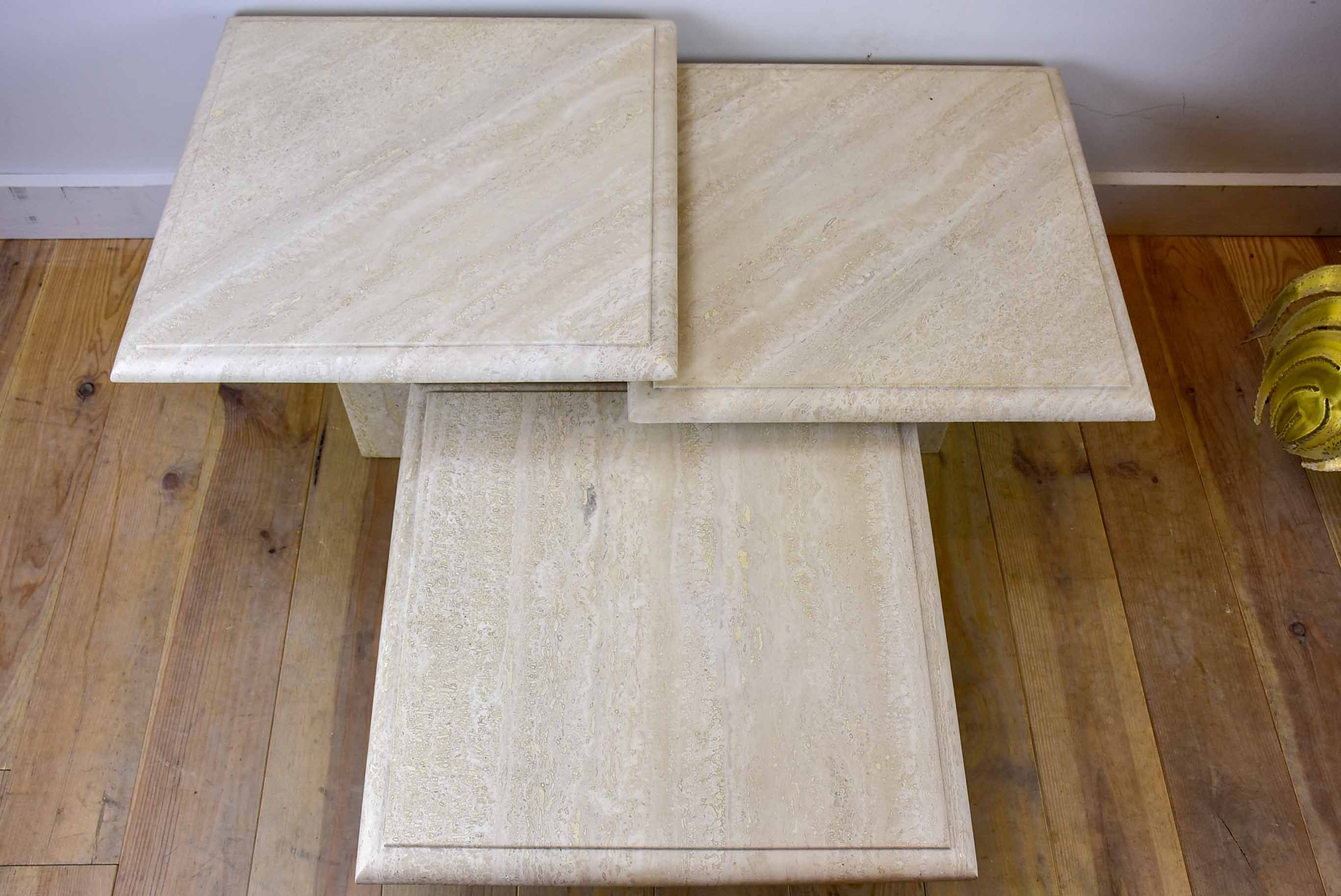 Three vintage travertine nesting side tables