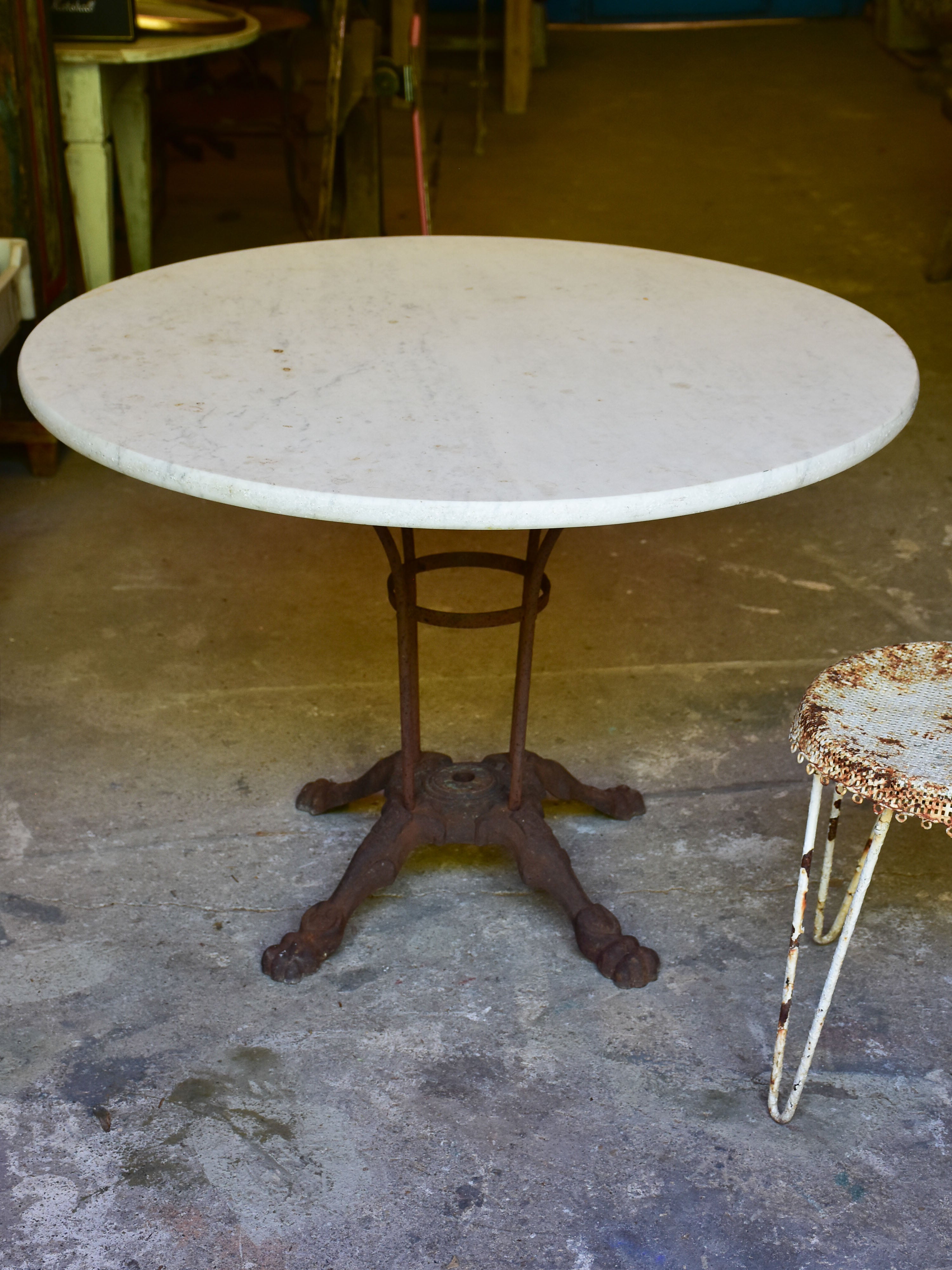 Round marble-top table with cast iron base