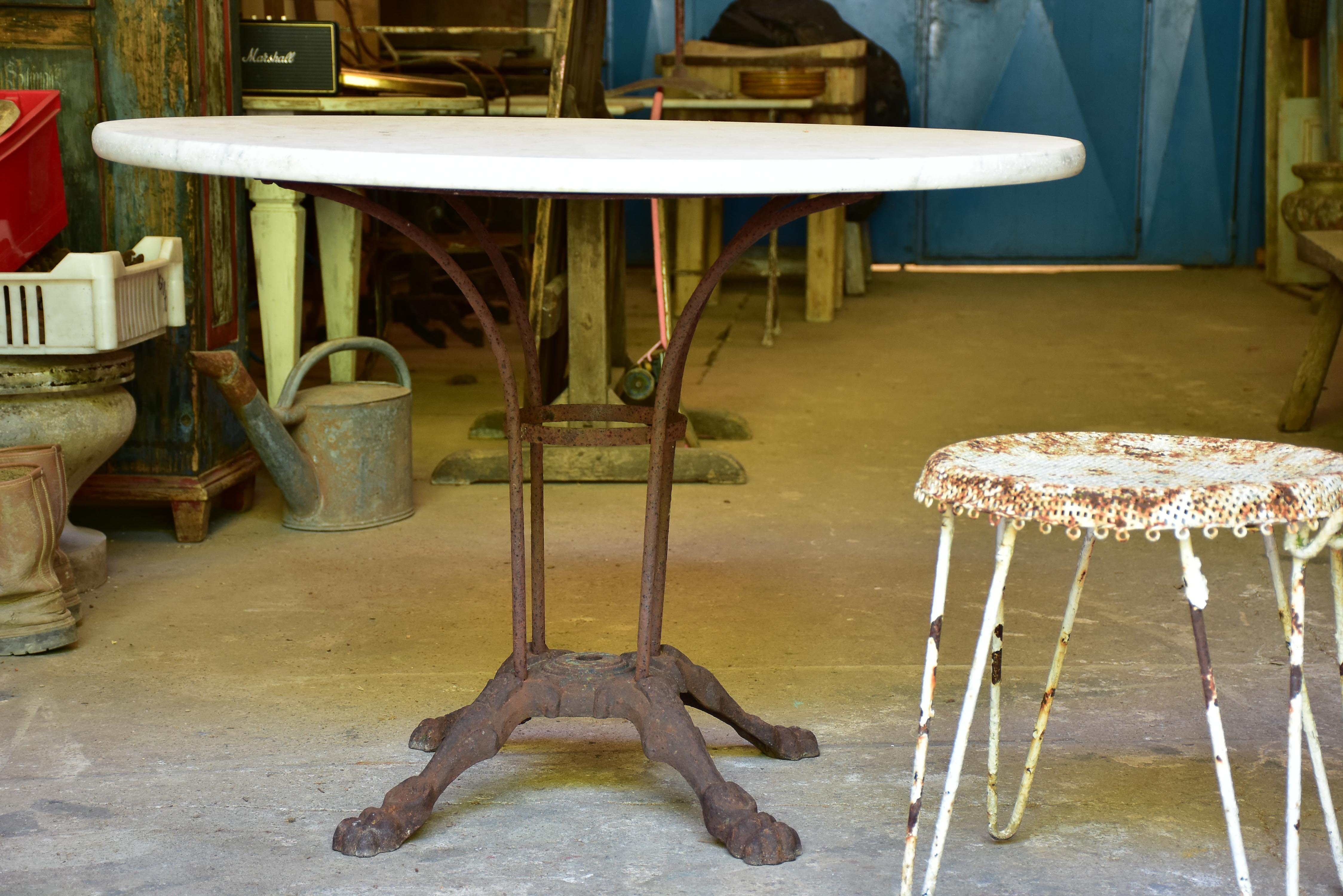 Round marble-top table with cast iron base