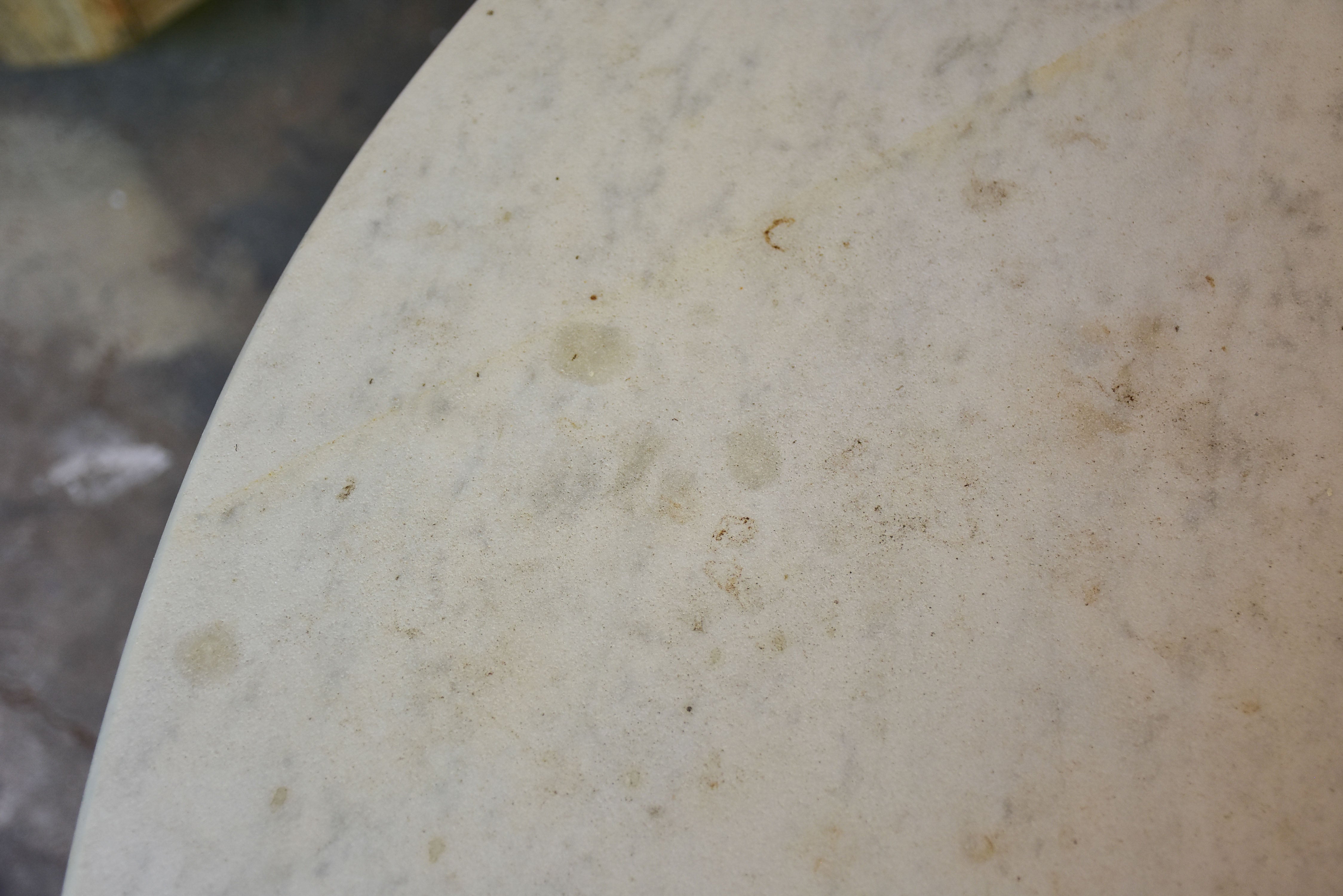 Round marble-top table with cast iron base