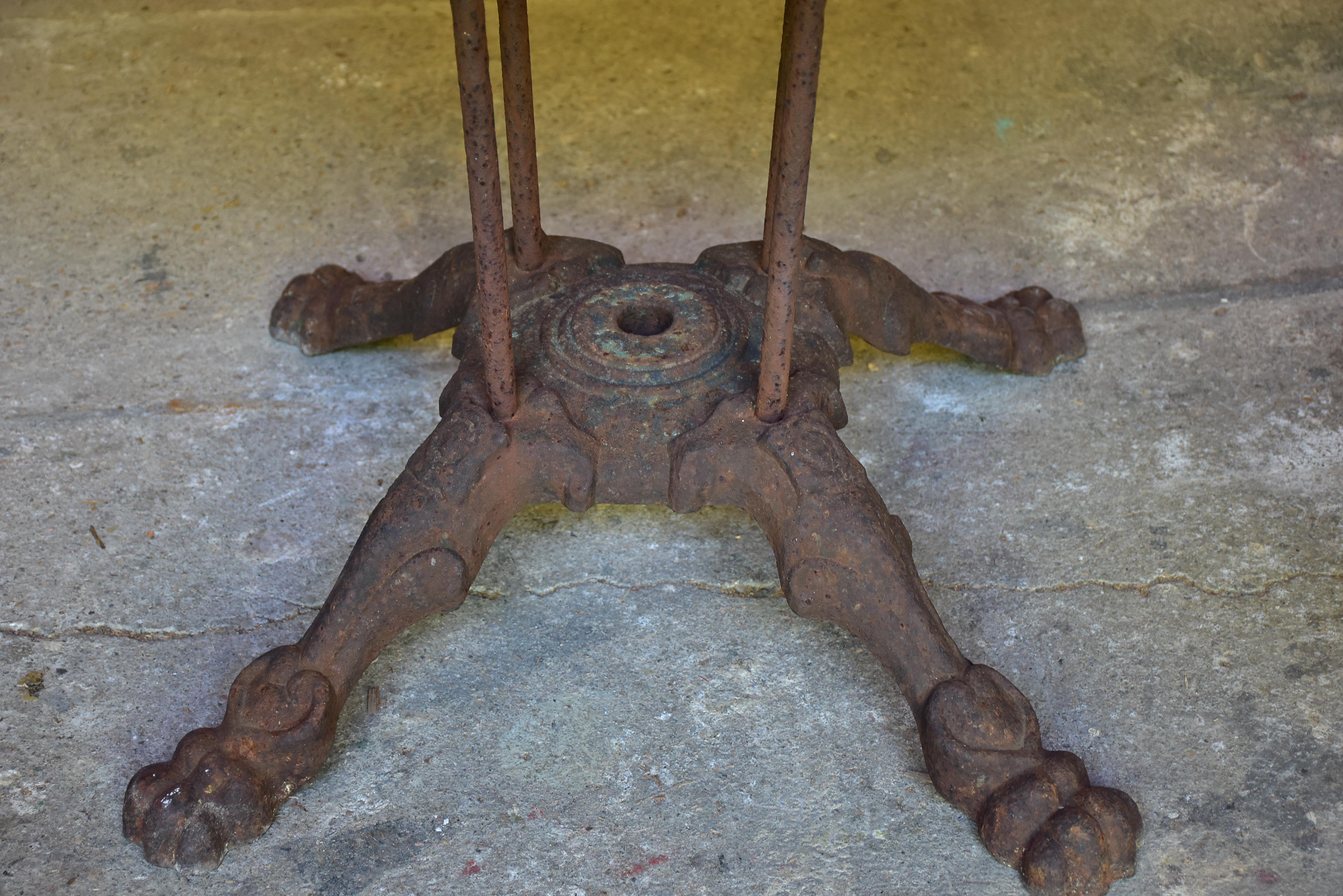 Round marble-top table with cast iron base