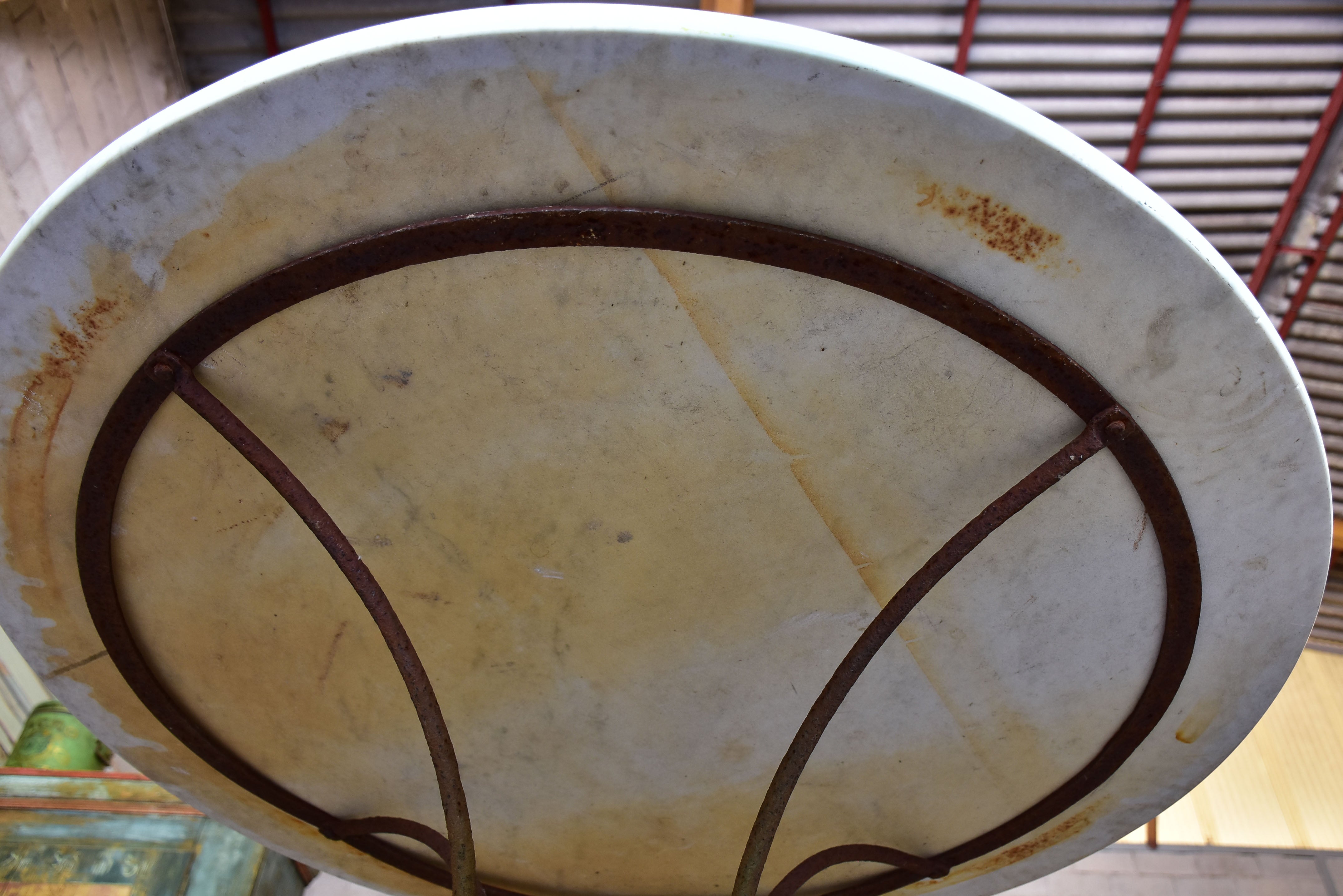 Round marble-top table with cast iron base