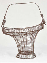Antique wire basket with whimsical design
