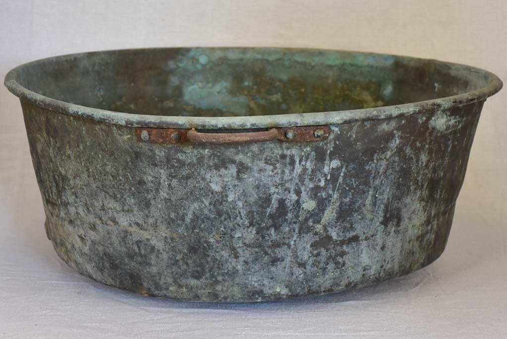 Broad antique French cauldron with two small handles and a drainage hole 30¼"